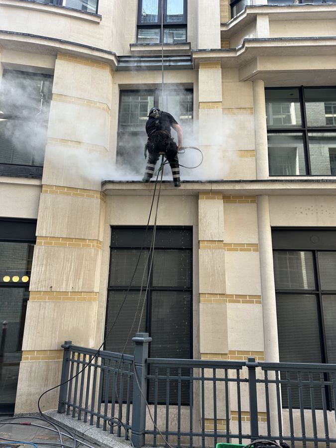Rope access DOFF cleaning on a stone façade