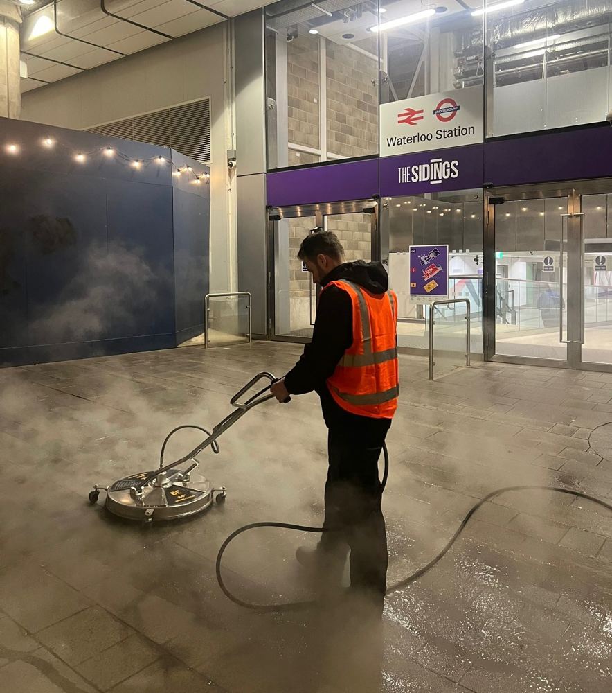 Hot-water rotary surface cleaning outside Waterloo Station